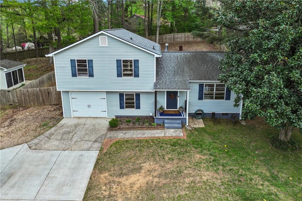3990 Pine Mountain Road Northwest Kennesaw, GA 30152 - Photo 25 of 32 a view of a house with a yard and lawn chairs