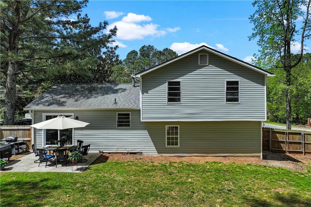 3990 Pine Mountain Road Northwest Kennesaw, GA 30152 - Photo 26 of 32 a view of a house with a yard and sitting area