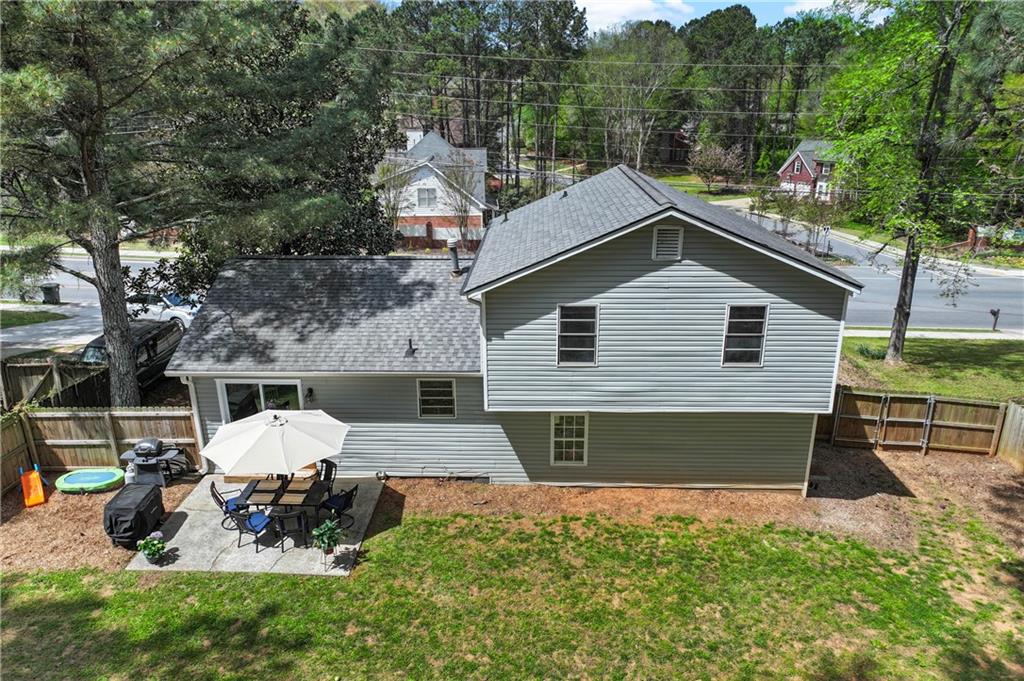 3990 Pine Mountain Road Northwest Kennesaw, GA 30152 - Photo 27 of 32 a view of a house with a yard and sitting area
