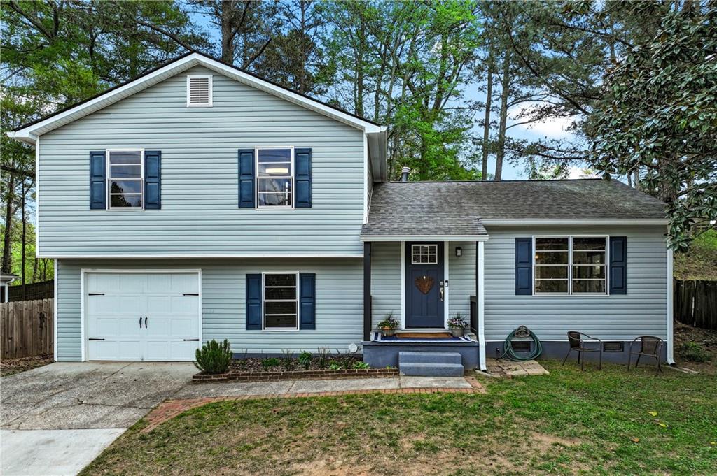 3990 Pine Mountain Road Northwest Kennesaw, GA 30152 - Photo 3 of 32 a front view of a house with garden