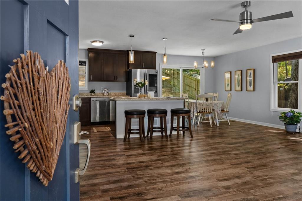3990 Pine Mountain Road Northwest Kennesaw, GA 30152 - Photo 6 of 32 a view of a dining room with furniture window and wooden floor