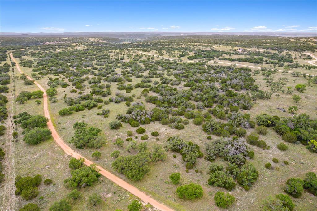 S3660 Seven Springs Ranch Junction Junction, TX 76849 - Photo 11 of 27 an aerial view of residential houses with outdoor space and trees