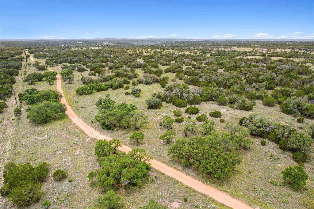 S3660 Seven Springs Ranch Junction Junction, TX 76849 - Photo 20 of 27 an aerial view of residential houses with outdoor space and trees