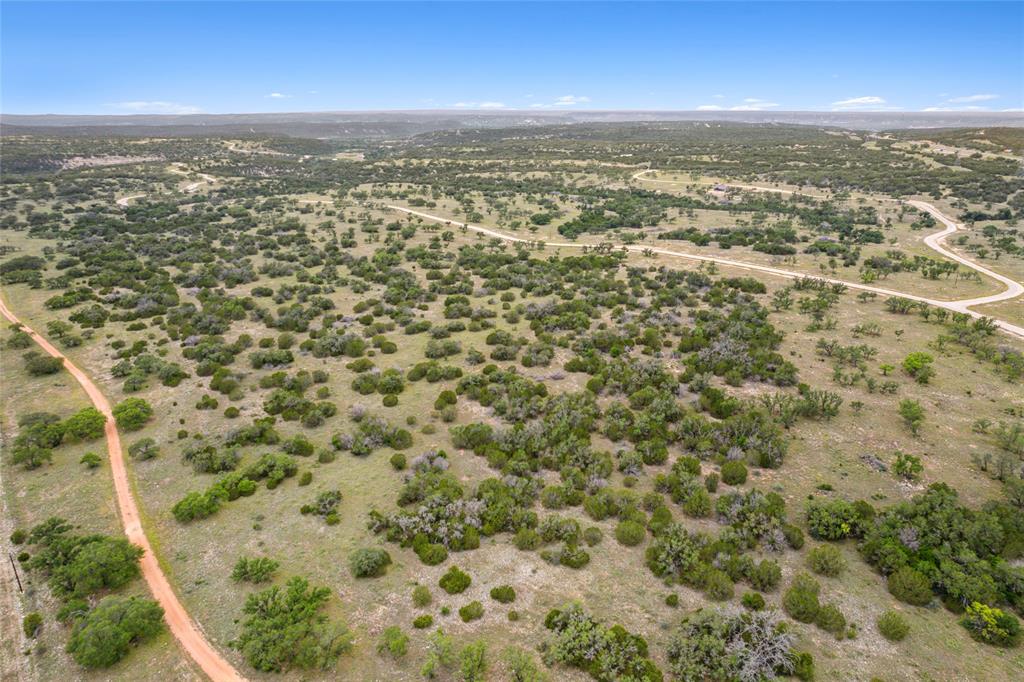 S3660 Seven Springs Ranch Junction Junction, TX 76849 - Photo 21 of 27 an aerial view of residential houses with outdoor space and trees