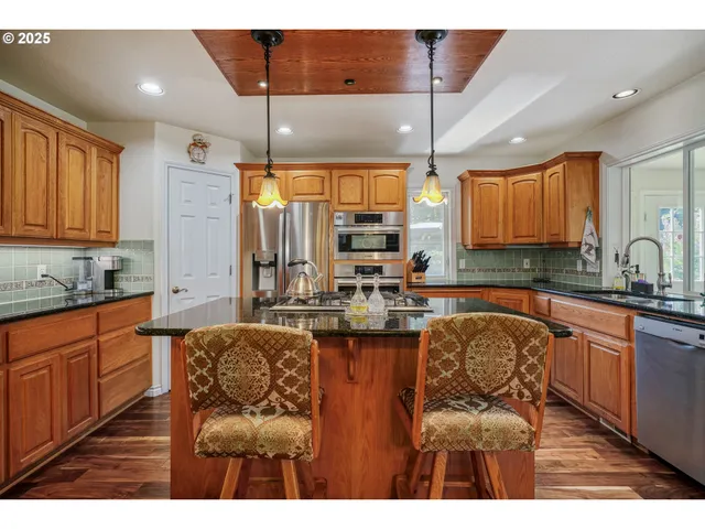 a kitchen with stainless steel appliances granite countertop a sink and cabinets