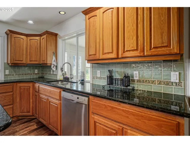 a kitchen with stainless steel appliances granite countertop a sink and cabinets