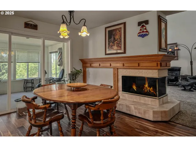 a view of a dining room with furniture and a fireplace