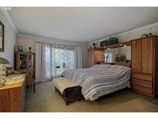 a bedroom with a bed window and dresser