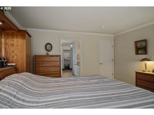 a bedroom with a bed and a flat tv screen