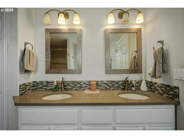 a bathroom with mirror sink and vanity