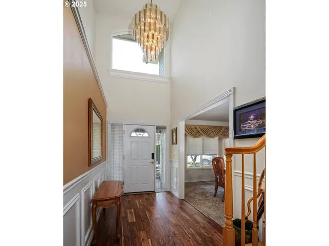 a view of a hallway with wooden floor and entryway