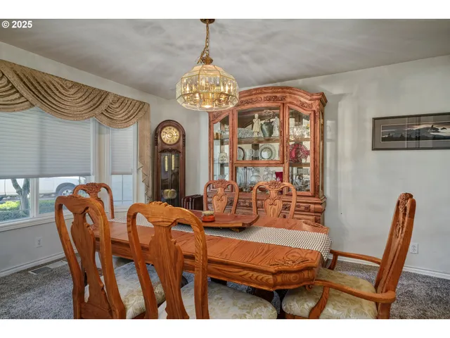 a view of a dining room with furniture and a chandelier