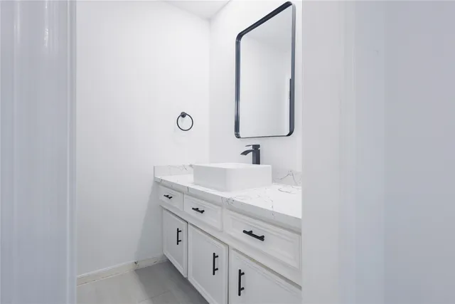 a bathroom with a double vanity sink and mirror