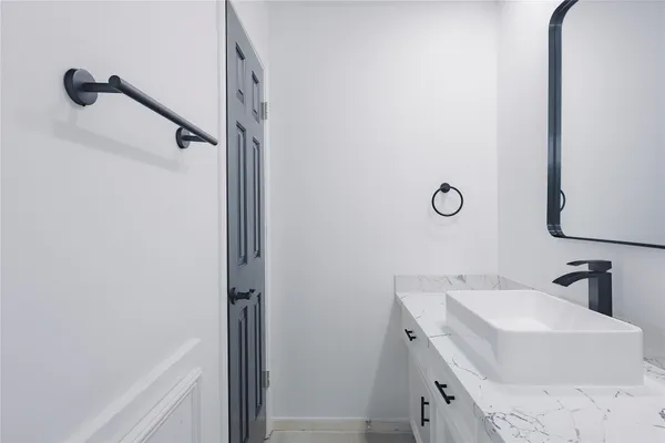 a bathroom with a sink vanity and mirror