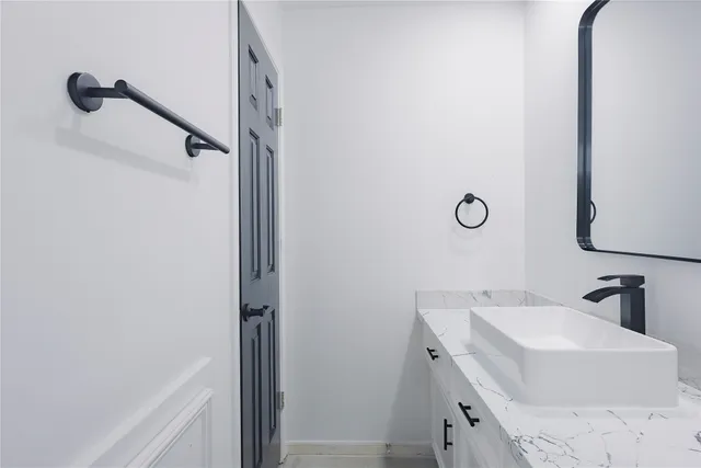 a bathroom with a sink vanity and mirror