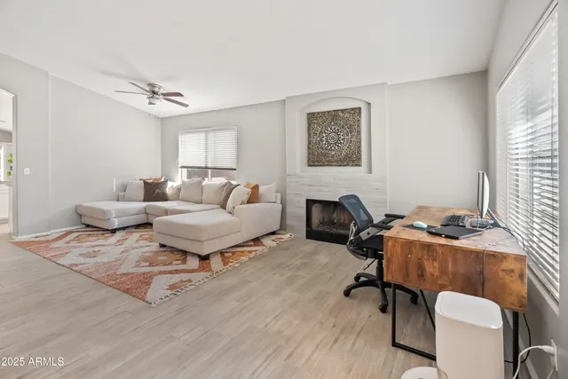 a living room with furniture a rug and a window