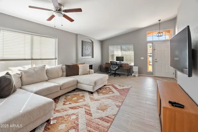 a living room with furniture and a flat screen tv