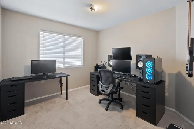 a view of a workspace with furniture and a window