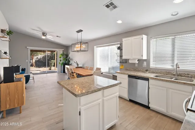 a kitchen with granite countertop attached living room