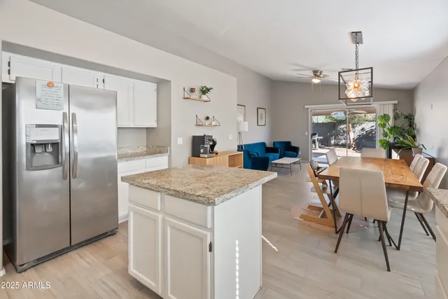 a kitchen with kitchen island a counter top space cabinets and stainless steel appliances