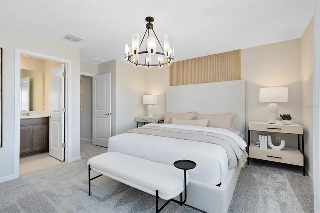 a bedroom with a bed and a chandelier