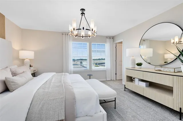 a bedroom with a bed a mirror and a window