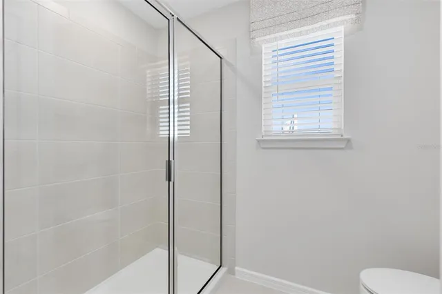 a bathroom with a shower and toilet