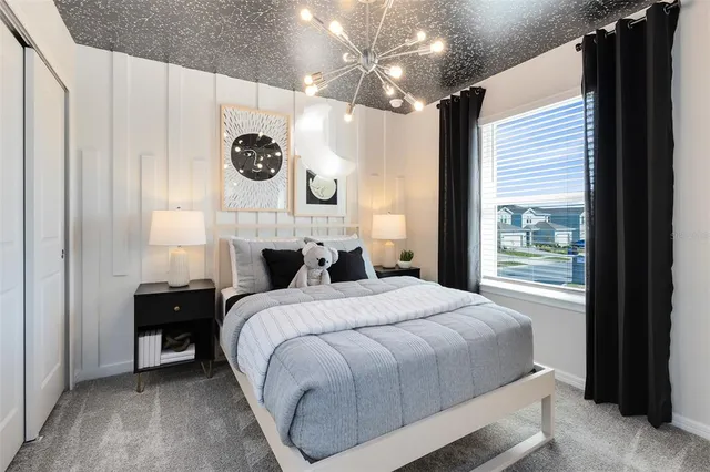 a bedroom with a bed a mirror and a window