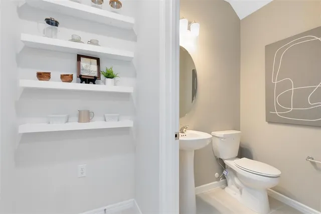 a white toilet sitting next to a bathroom sink
