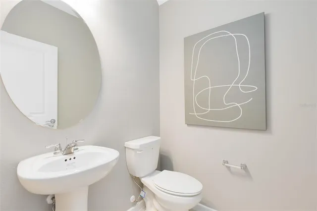 a bathroom with a sink a mirror and a toilet