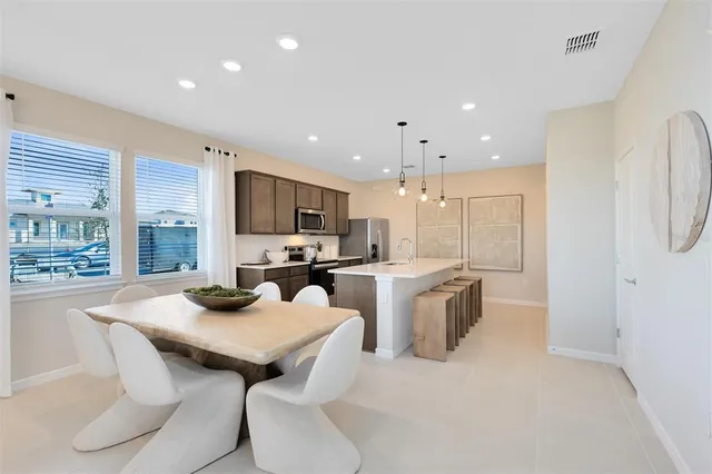 a kitchen with stainless steel appliances kitchen island granite countertop a sink and cabinets