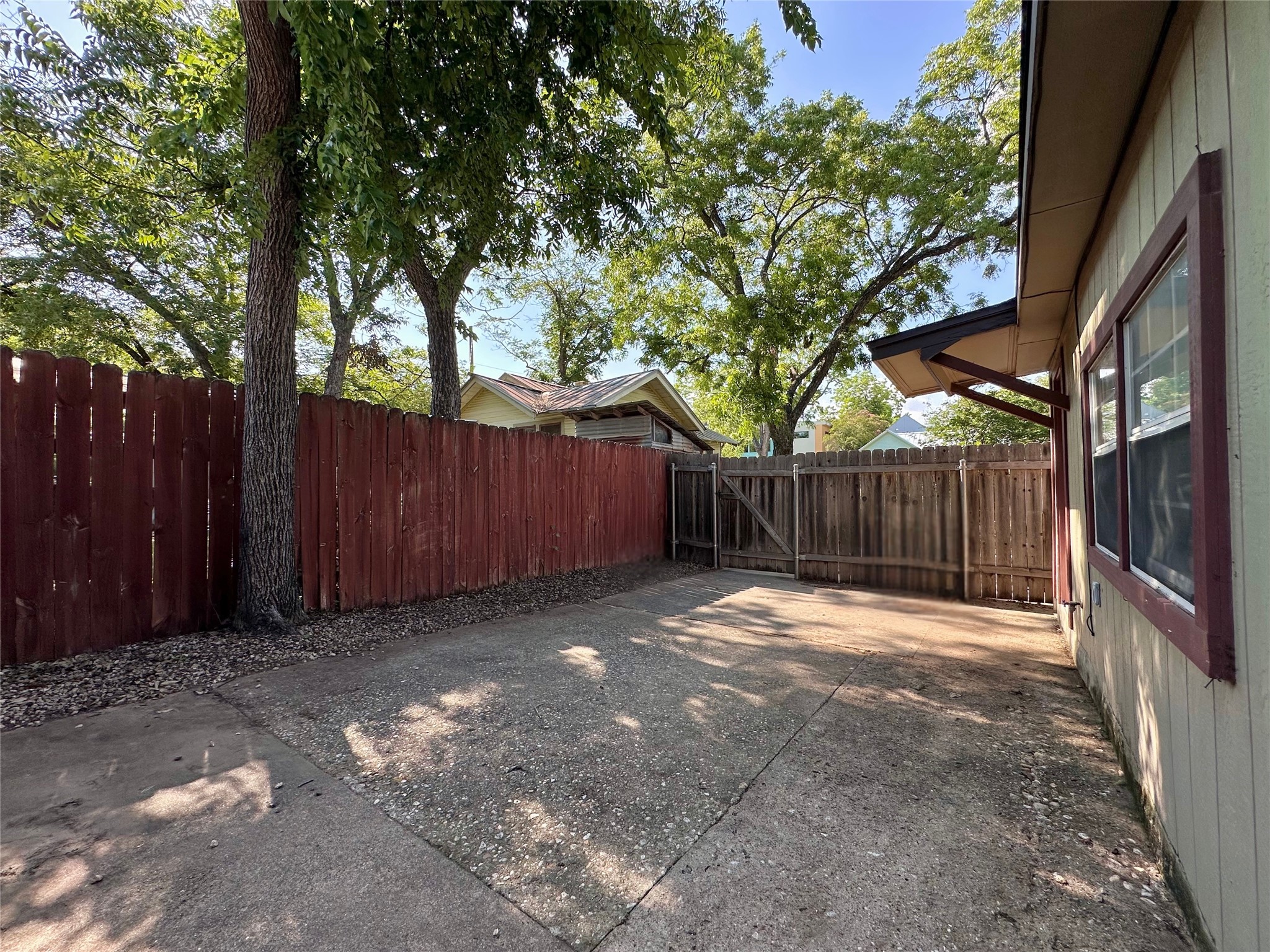 2103 East 16th Street, Unit ANNEX Austin, TX 78702 - Photo 20 of 23 a backyard of a house with trees and wooden fence