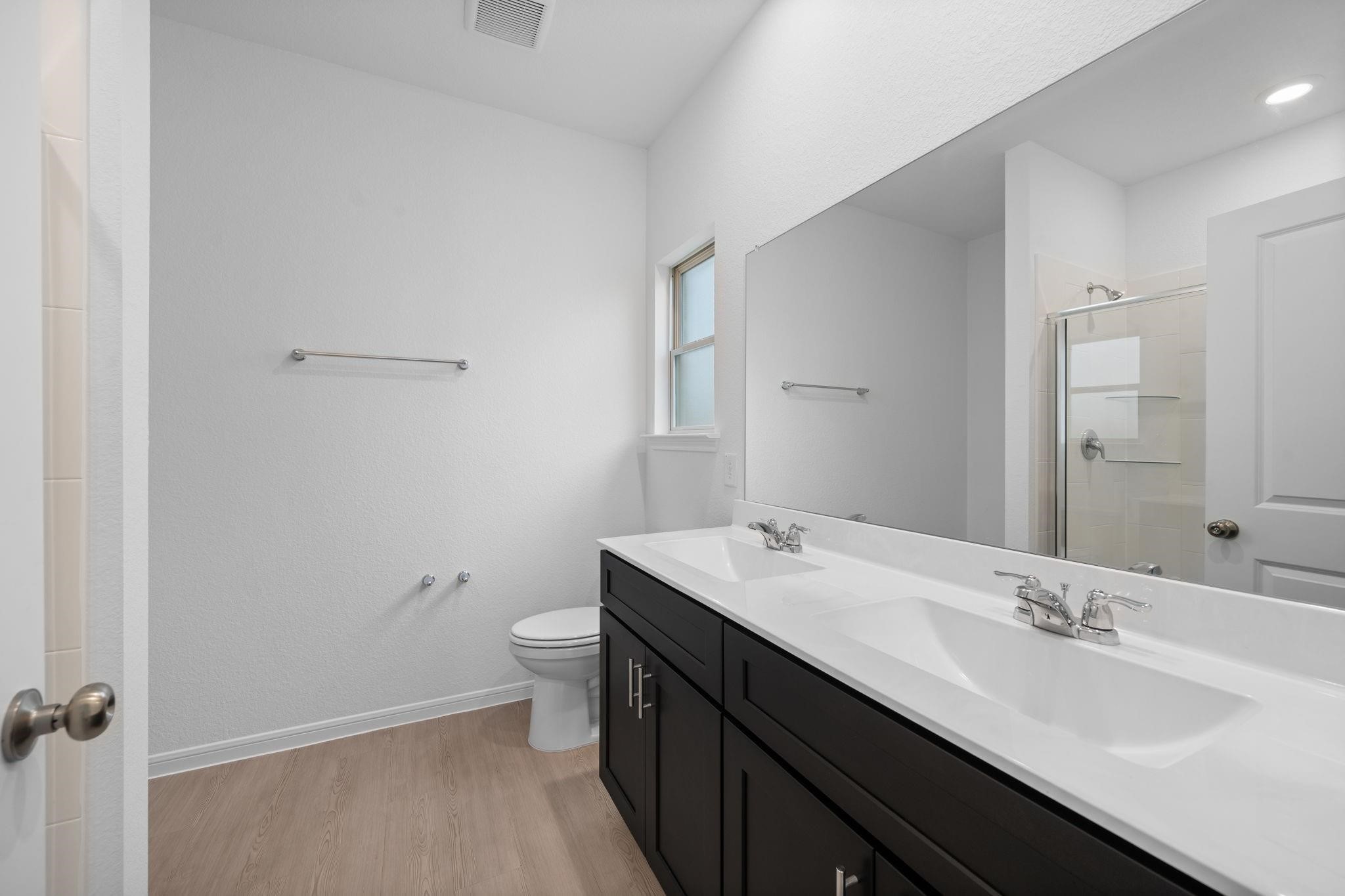 9015 Cedar Cres Drive Baytown, TX 77521 - Photo 13 of 26 a bathroom with a double vanity sink toilet and a mirror