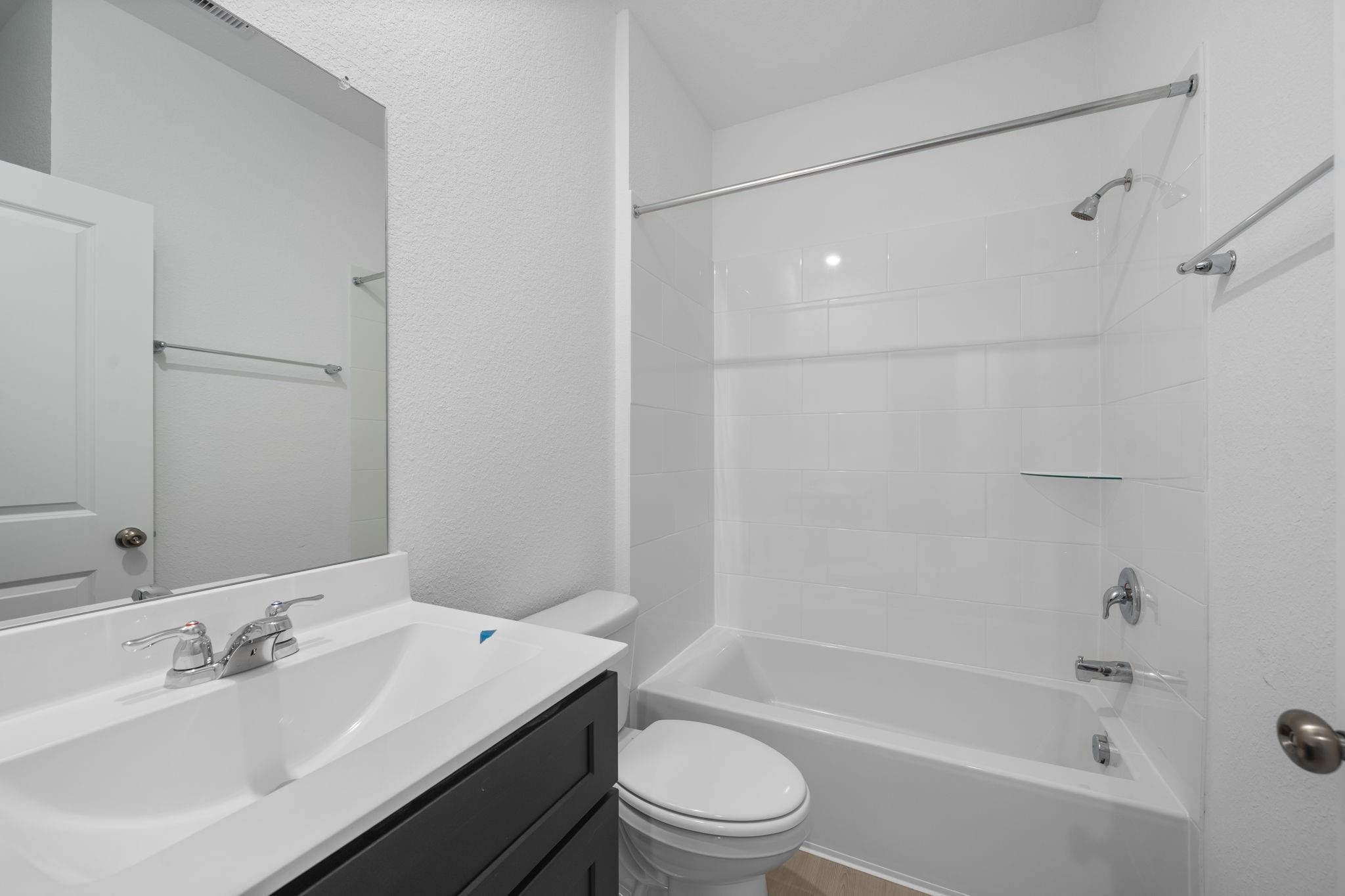 9015 Cedar Cres Drive Baytown, TX 77521 - Photo 14 of 26 a bathroom with a bathtub shower sink vanity mirror and toilet