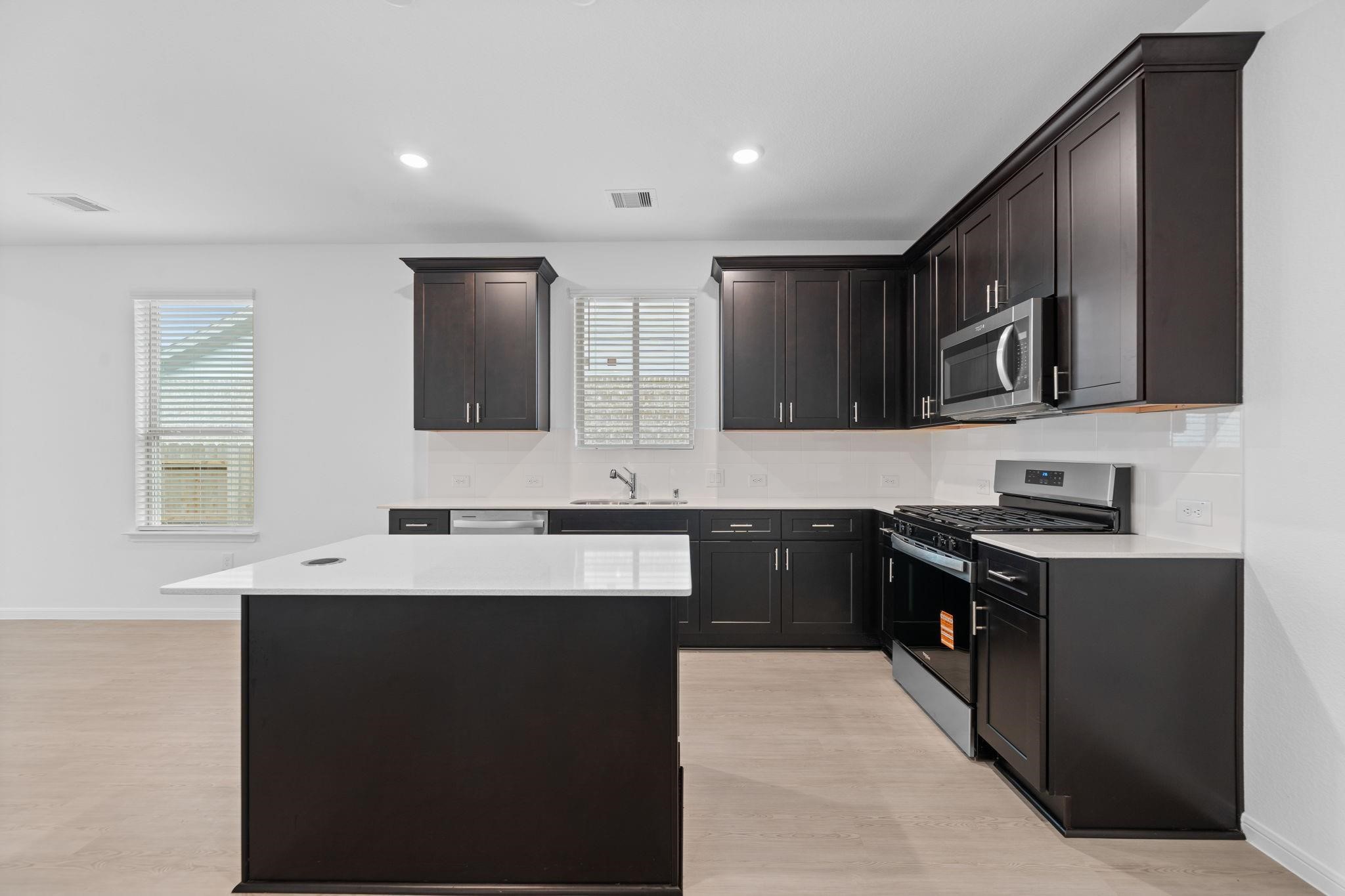 9015 Cedar Cres Drive Baytown, TX 77521 - Photo 2 of 26 a kitchen with stainless steel appliances granite countertop a sink stove and microwave