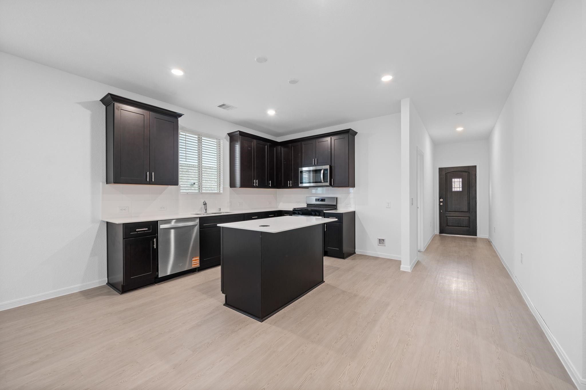 9015 Cedar Cres Drive Baytown, TX 77521 - Photo 4 of 26 a large kitchen with stainless steel appliances granite countertop a stove a sink and a refrigerator