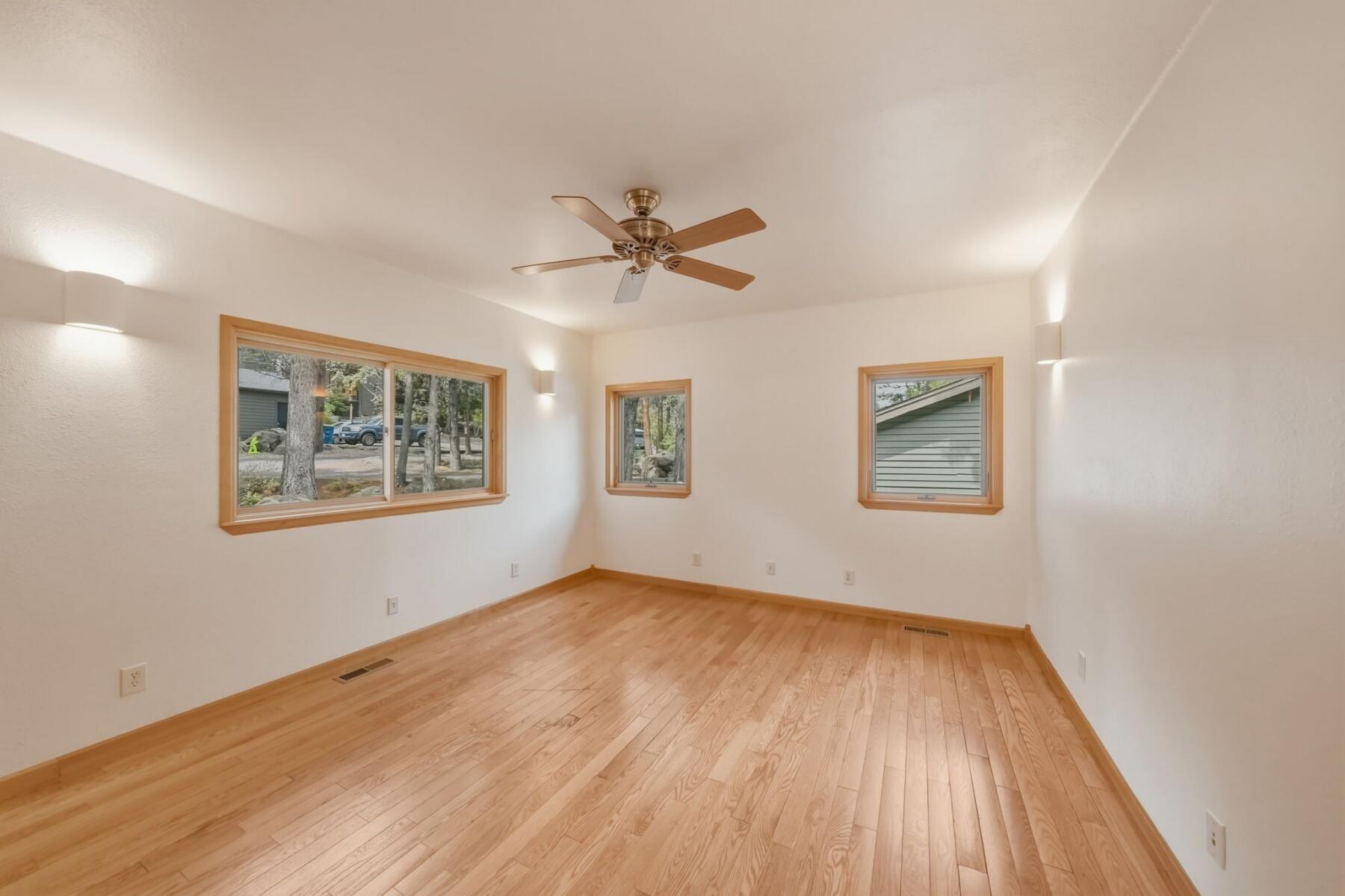 637 Northwest Silver Buckle Road Bend, OR 97703 - Photo 19 of 68 an empty room with wooden floor and windows