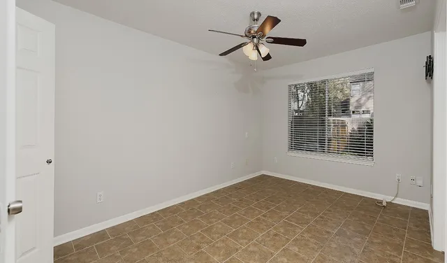 a view of a big room with wooden floor and windows