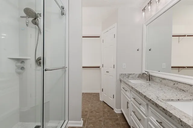 a bathroom with a granite countertop sink mirror and double
