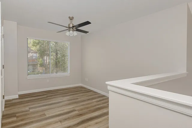 a utility room with closet and windows