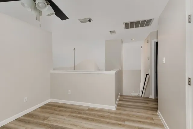 a view of a room with wooden floor