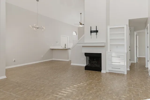 a view of a livingroom with a fireplace and window