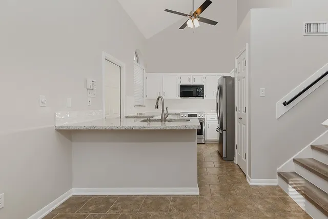 a kitchen with stainless steel appliances a sink stove and refrigerator