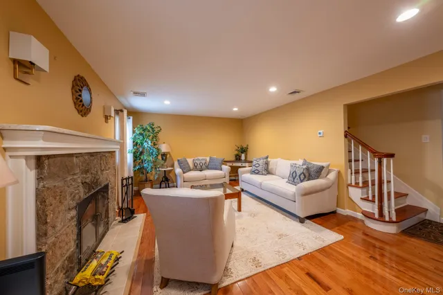 a living room with fireplace furniture and a wooden floor