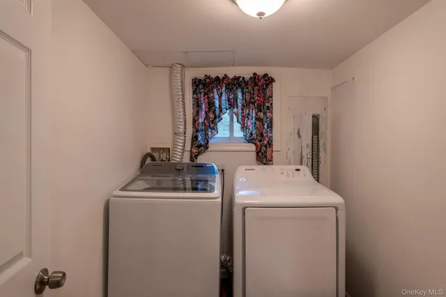 a view of storage and utility room with washer and dryer