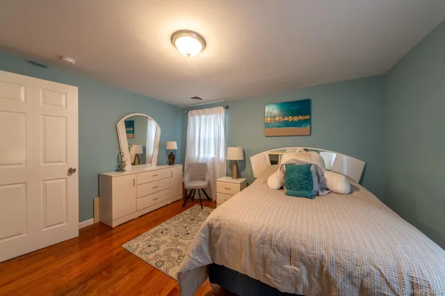 a bedroom with a large bed and a dresser