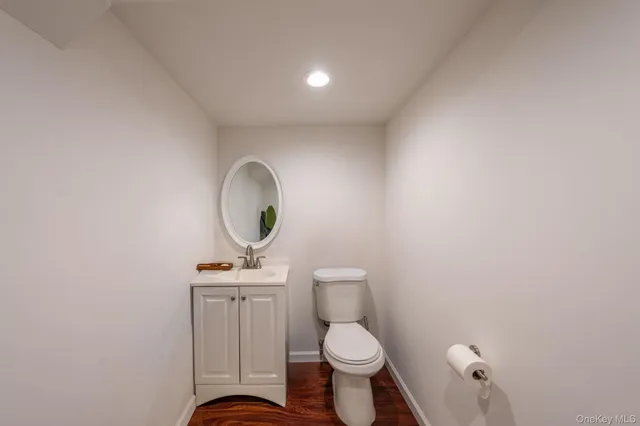 a bathroom with a toilet a sink and a mirror