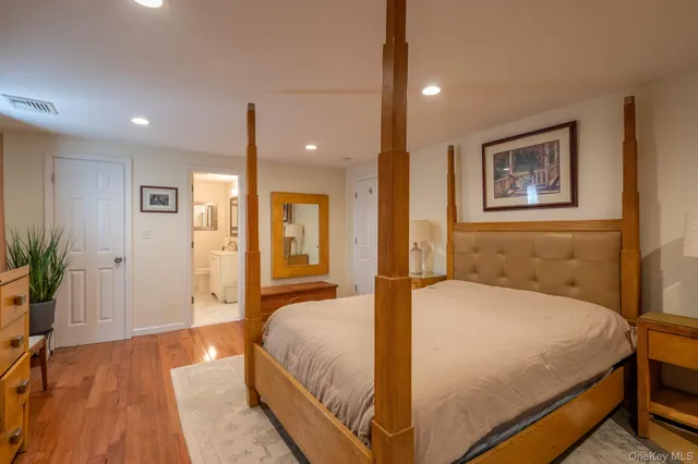 a spacious bedroom with a bed and a potted plant