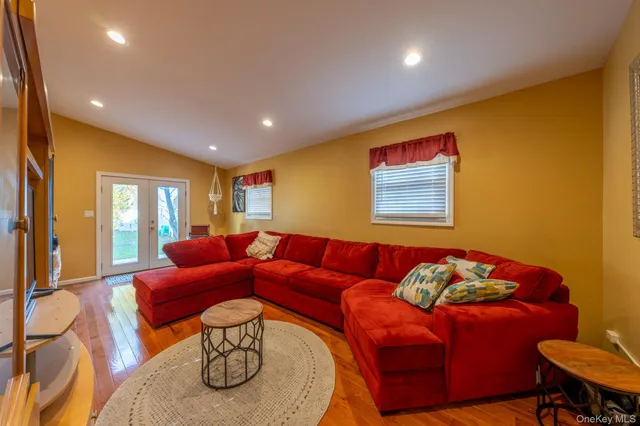 a living room with furniture a couch and a potted plant