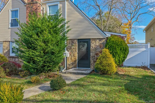 a view of a house with a yard and plants